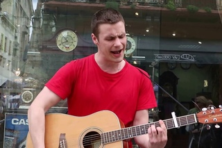 Street musician singing cover on “Queen - Mama“ in Lviv